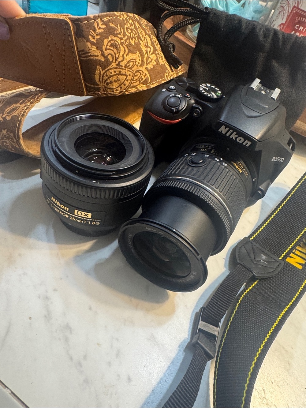 Nikon Black DSLR with Black Lenses and Yellow-Trim Strap